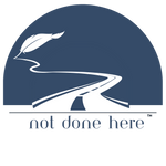 Logo featuring Blue arc with a quill pen drawing a winding road with the comapny name "not done here ™" written below that also in navy blue.